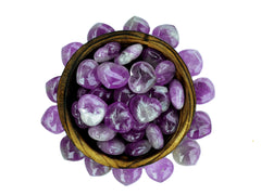 Several mini amethyst crystal hearts 30mm inside a wood bowl on white background