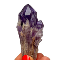 One elestial amethyst stone on hand with white background