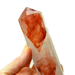 One fire quartz crystal prism 90mm on hand wih white background