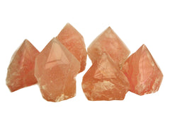 Six semi polished rose quartz points 70mm-90mm on white background