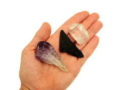 Raw amethyst point, black kyanite and crystal quartz point 30mm-40mm on hand with white background