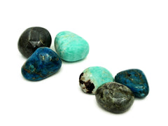 Two large labradorite, blue apatite and green amazonite tumbled stones in two groups on white background
