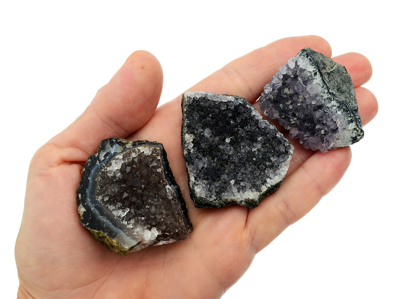 Three druzy amethyst crystals 40mm-50mm on hand with white background