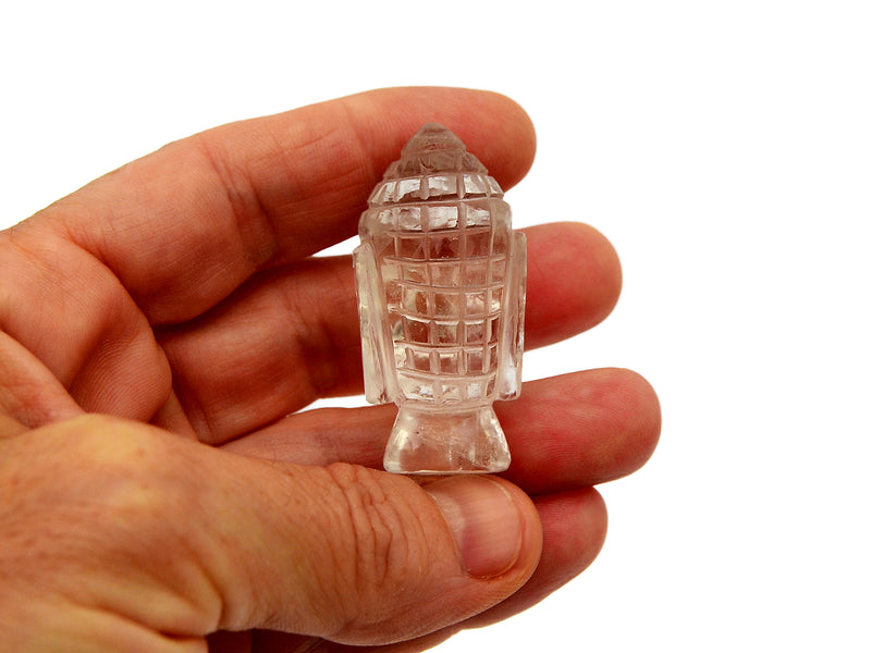Reverse of one mini clear quartz buddha head sculpture 40mm on hand with white background