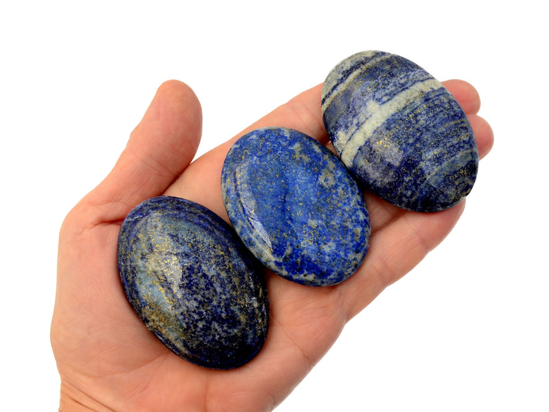 Three lapis lazuli palm stones 55mm-60mm on hand with white backround