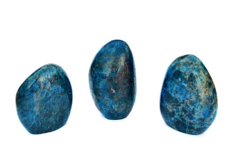 Three large blue apatite free form minerals 100mm-130mm on white background