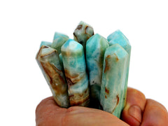 Some blue aragonite small tower points 50mm on hand with white background