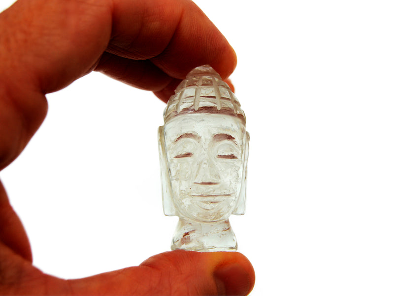 One mini clear quartz buddha head sculpture 45mm on hand with white background