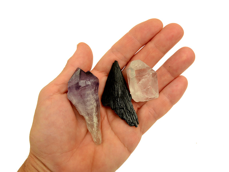 One raw amethyst crystal point, raw black kyanite and clear quartz point 30mm-40mm on hand with white background