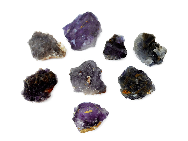 Some raw purple cubic fluorite on white background