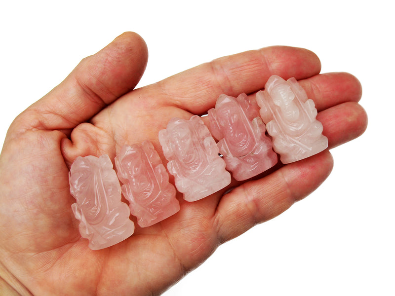 Five mini pink quartz ganesha sculptures 30mm-35mm on hand with white background