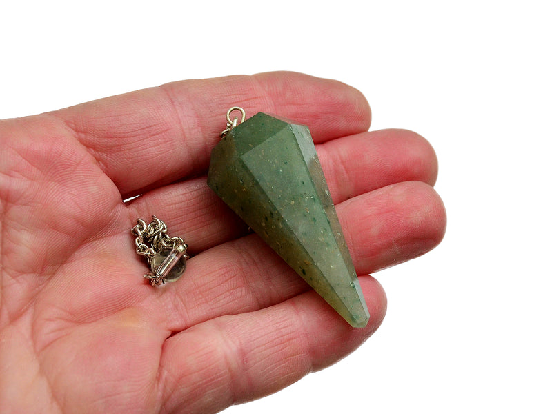 One green aventurine crystal pendulum with silver chain on hand with white background
