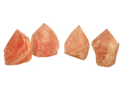 Four semi polished pink quartz points 55mm-70mm on white background