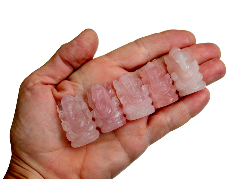 Five mini rose quartz ganesha sculptures 30mm-35mm on hand with white background