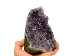 One lavender druzy amethyst cut base 120mm on hand with white background
