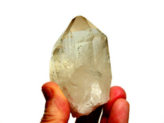 One large rough celar quartz point 150g on hand with white background