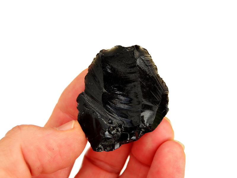 Raw black obsidian crystal 40mm on hand with white background