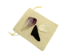 One raw amethyst point, black kyanite and clear quartz point 30mm-40mm on small jute bag