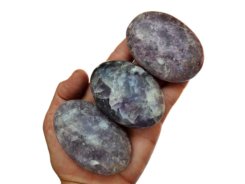 Three purple lepidolite palm stones 55mm-70mm on hand with white background