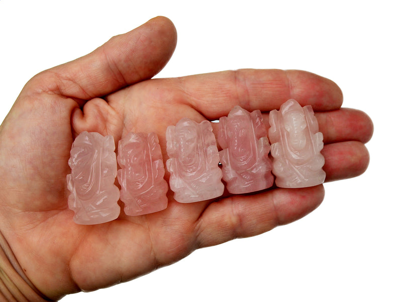 Five mini pink quartz ganesha figures 30mm-35mm on hand with white background