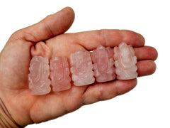 Five mini pink quartz ganesha figures 30mm-35mm on hand with white background