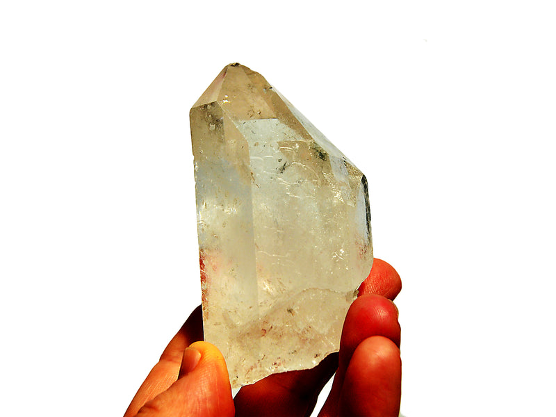 One natural clear quartz point 150g on hand with white background