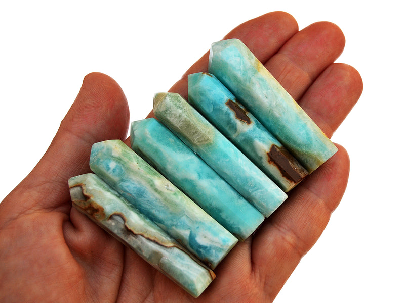 Six blue aragonite crystal points 50mm onhand with white background