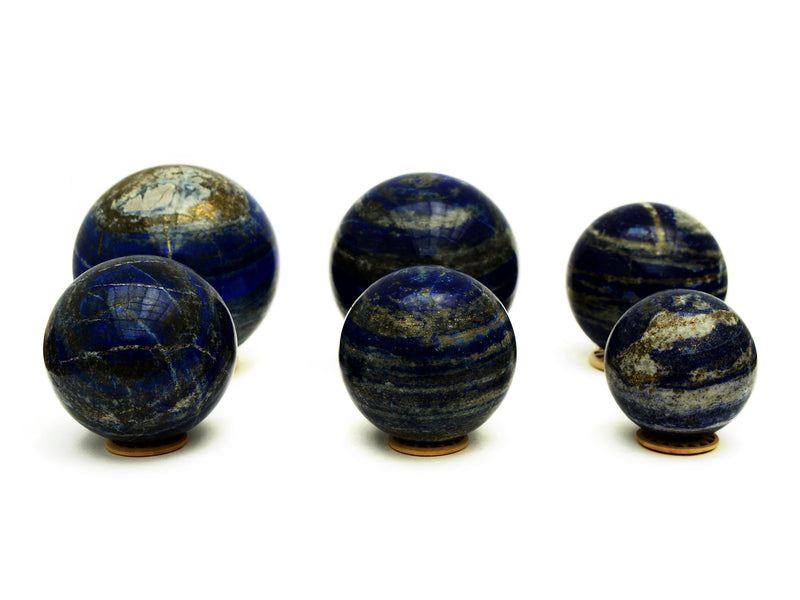 Six lapis lazuli spheres 60mm-105mm on white background