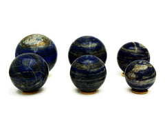 Six lapis lazuli spheres 60mm-105mm on white background