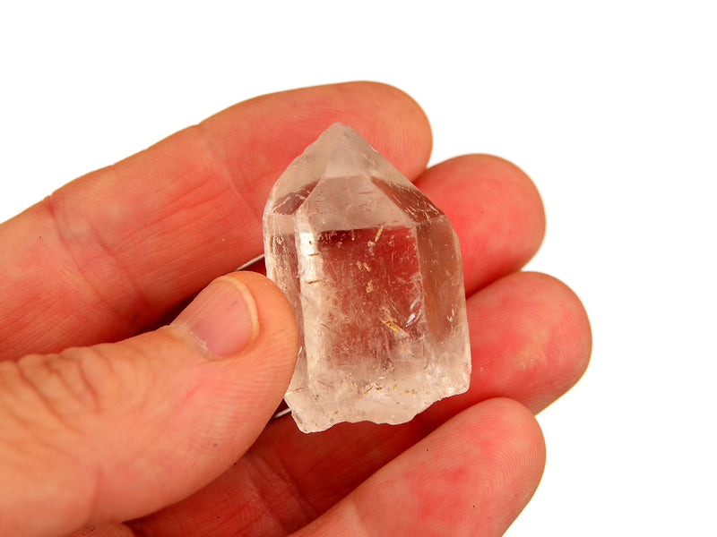 One natural clear quartz point 30mm on hand with white background