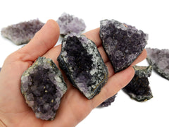 Three natural amethyst druzy crystals 50mm-70mm on hand with white background