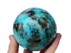 Amazonite sphere 80mm on hand with white background