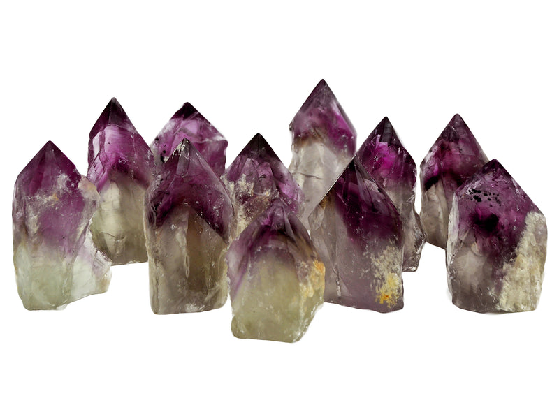Several amethyst semi polished points 65mm-90mm on white background