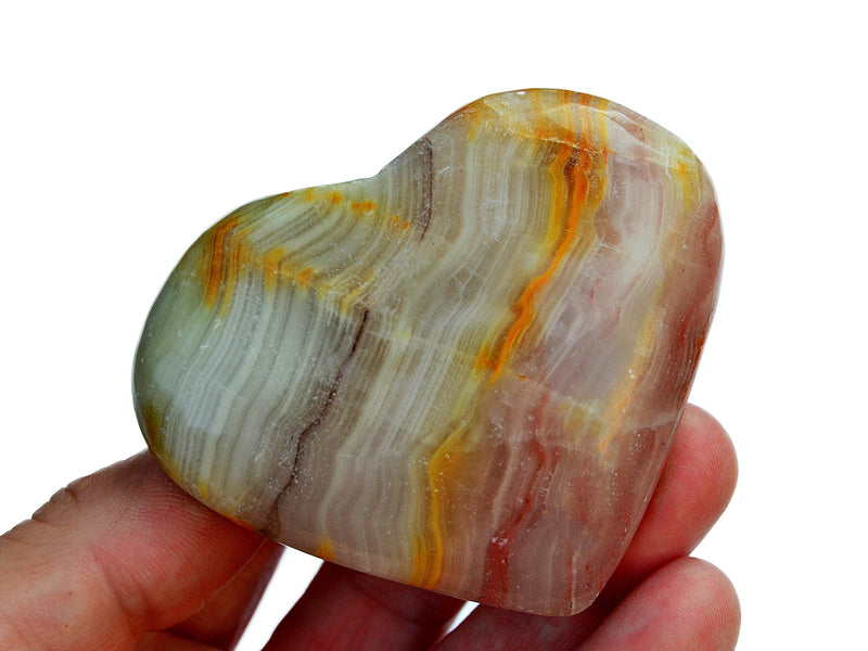 One pink banded onyx heart shapped crystal 70mm on hand with white background