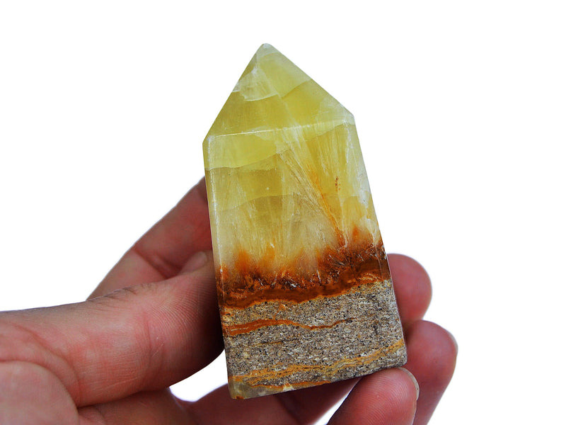 Three lemon calcite crystal tower 60mm on hand with white background