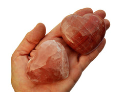Rose calcite heart stones 60mm-65mm on hand with white background