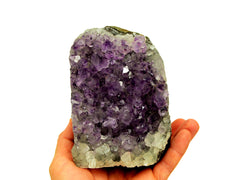 One large purple amethyst druzy cut base stone 118mm on hand with white background