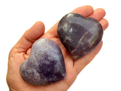 Two purple lepidolite heart minerals 60mm-70mm on hand with white background