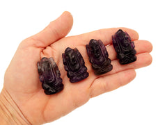 Four mini amethyst ganesha stone figures 35mm on hand with white background