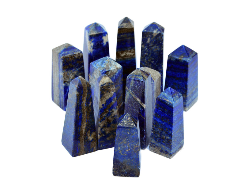 Several blue lapis lazuli crystal towers 60mm-100mm on white background