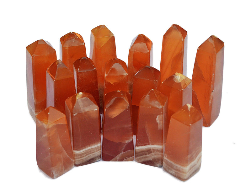 Several banded honey calcite crystal towers 60mm-90mm on white background
