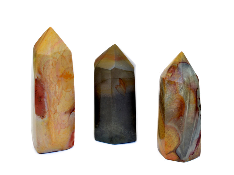 Three large polychrome jasper tower crystals on white background