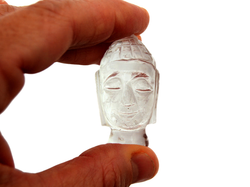 One mini clear quartz buddha head figure 45mm on hand with white background