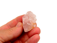 One raw pink quartz 30mm on hand with white background