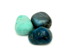 One large blue apatite, labradorite and green amazonite tumbled stones on hand with white background