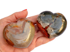 Two large polychrome jasper crystal heart 70mm on hand with white background