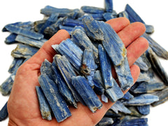 Some rough blue kyanite rod stones 30mm-70mm on hand with white background