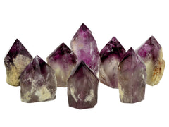 Some amethyst semi polished points 65mm-90mm on white background