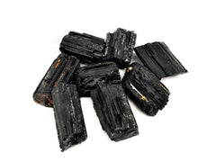 Eight rough black tourmaline crystals 25mm-60mm on white background