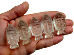 Five mini clear quartz buddha head sculptures 35mm-40mm on hand with white background
